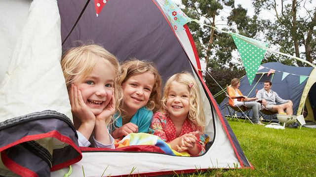 Luxury camping and glamping gear: family on campsite